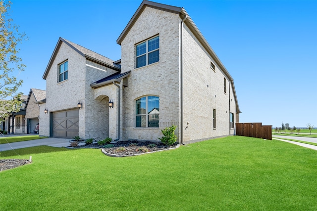 view of front of home with a garage and a front lawn