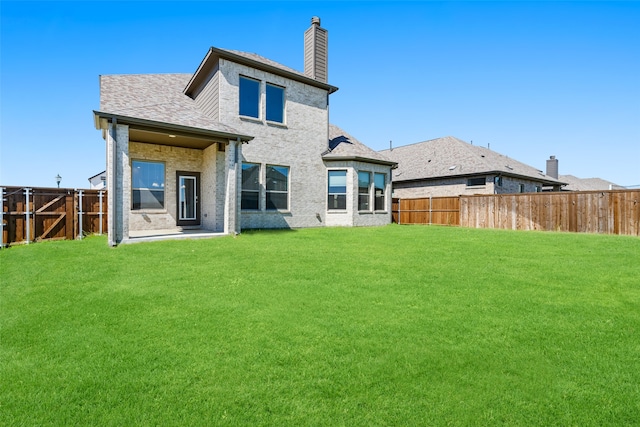 back of house featuring a lawn