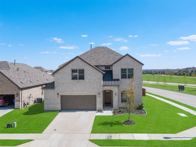 view of front of property with a front yard, central air condition unit, and a garage