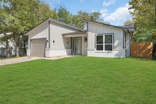 view of front of home with a front yard and a garage