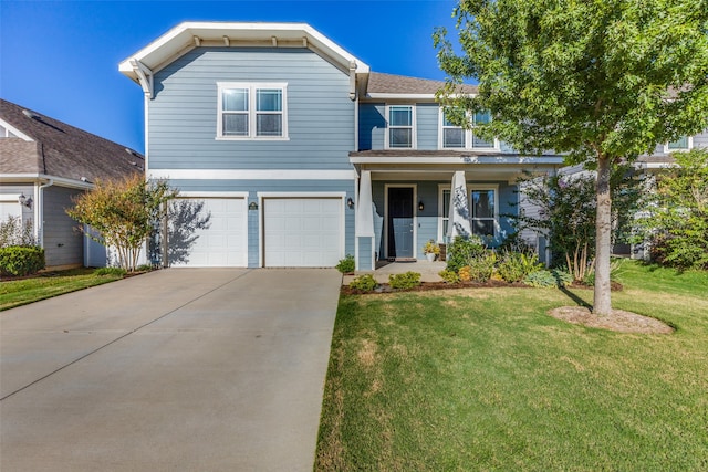 view of property featuring covered porch, a front yard, and a garage