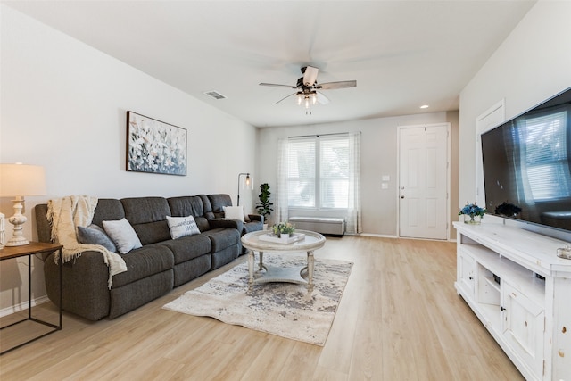 living room with ceiling fan and light wood-type flooring