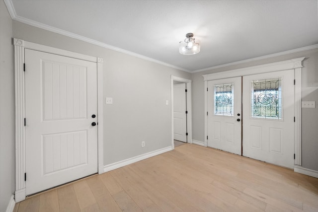 entryway featuring french doors, light hardwood / wood-style flooring, and crown molding