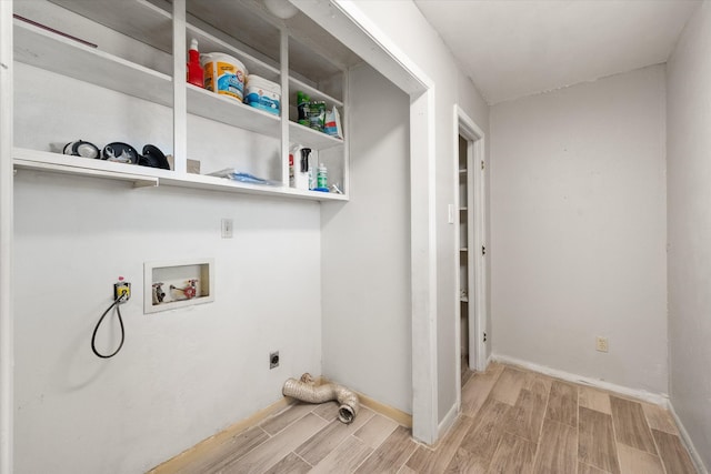 laundry room with washer hookup, light hardwood / wood-style flooring, and hookup for an electric dryer