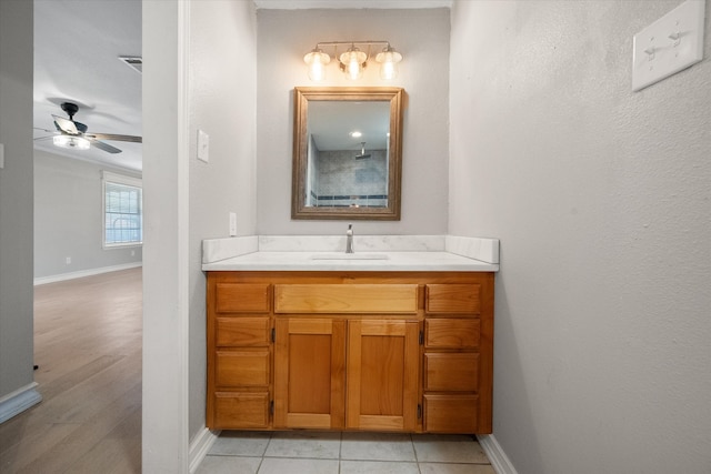 bathroom with wood-type flooring, vanity, and ceiling fan