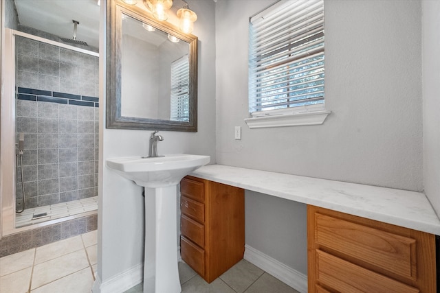 bathroom with tile patterned flooring and tiled shower