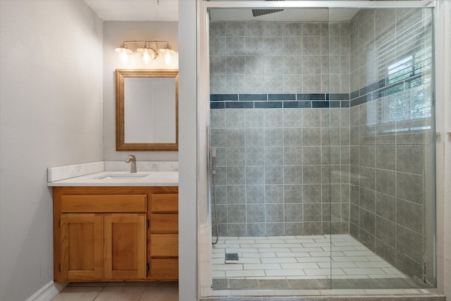 bathroom with vanity, tile patterned floors, and a shower with door