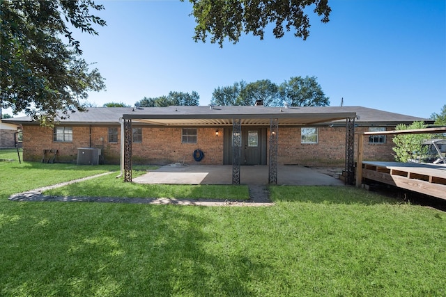 rear view of house featuring cooling unit, a yard, and a patio area