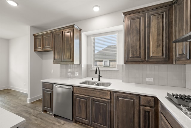 kitchen featuring dark brown cabinetry, tasteful backsplash, hardwood / wood-style flooring, sink, and dishwasher