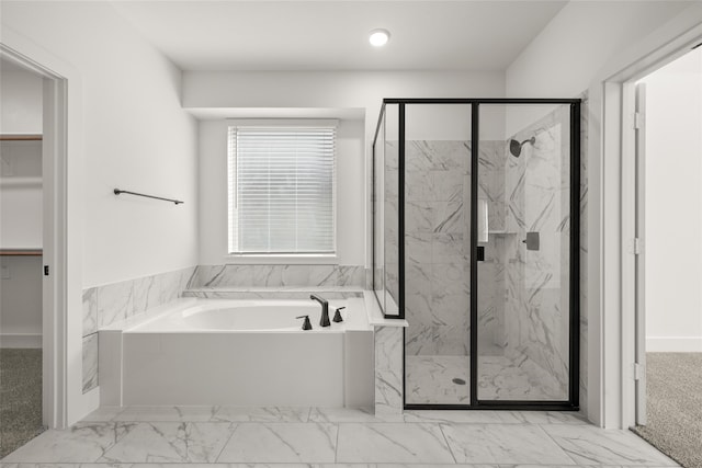 bathroom featuring shower with separate bathtub