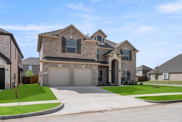 traditional home featuring a front lawn, driveway, fence, brick siding, and an attached garage