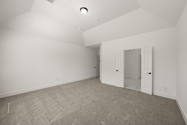 unfurnished bedroom with vaulted ceiling, carpet flooring, and baseboards
