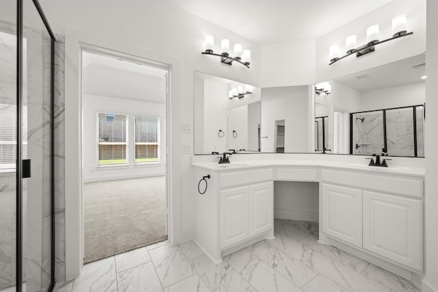 full bath featuring double vanity, marble finish floor, a marble finish shower, and a sink