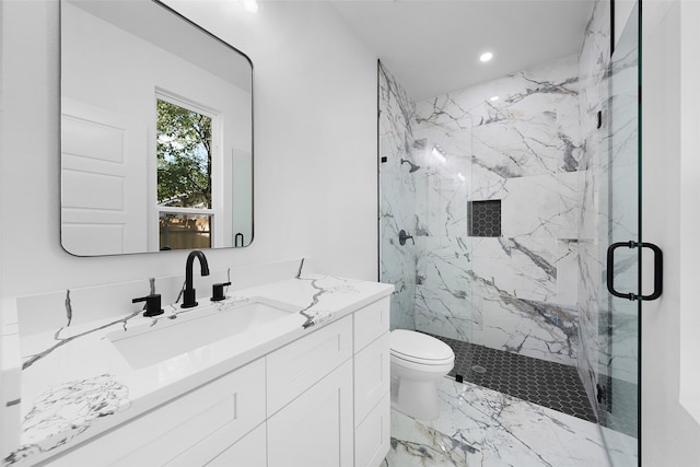 bathroom with a shower with shower door, vanity, and toilet