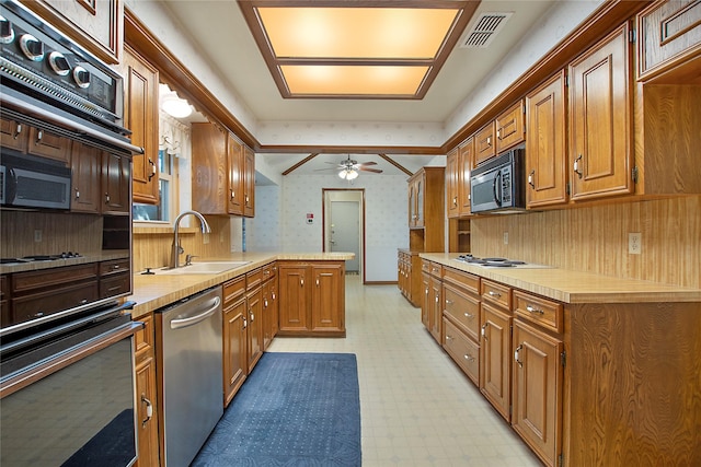 kitchen with black microwave, a sink, visible vents, dishwasher, and wallpapered walls