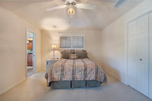 bedroom featuring ceiling fan, light colored carpet, and a closet