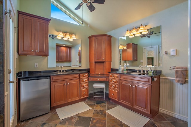 bathroom with lofted ceiling, two vanities, and a sink