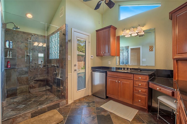 bathroom with plenty of natural light, tiled shower, vaulted ceiling, and vanity