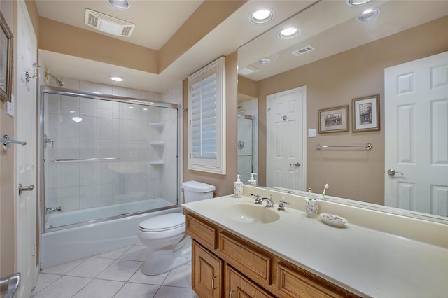 full bathroom with vanity, toilet, enclosed tub / shower combo, and tile patterned floors