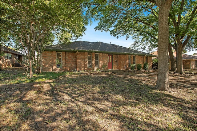 rear view of property with brick siding