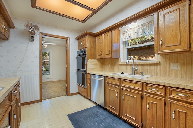 kitchen featuring sink, dishwasher, ceiling fan, and black double oven