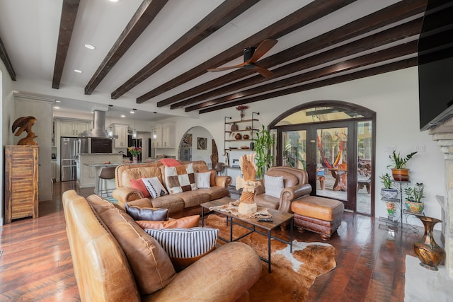 living room with beam ceiling, dark hardwood / wood-style flooring, ceiling fan, and french doors