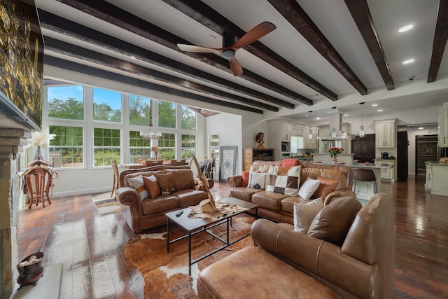 living room featuring beamed ceiling, ceiling fan with notable chandelier, and hardwood / wood-style floors