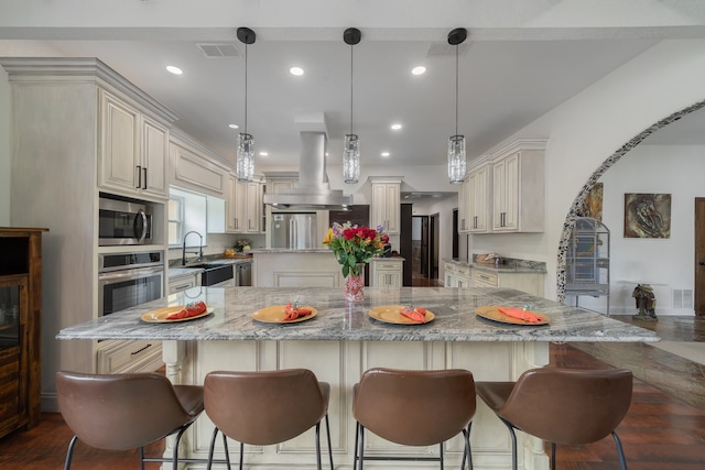 kitchen with hanging light fixtures, a large island, and stainless steel appliances