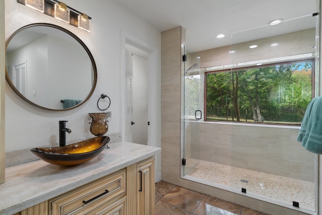 bathroom featuring an enclosed shower and vanity