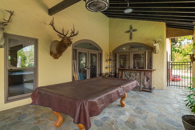 recreation room featuring french doors, vaulted ceiling with beams, and billiards