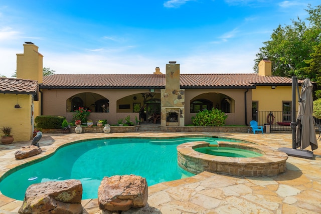 view of swimming pool with a patio and an in ground hot tub