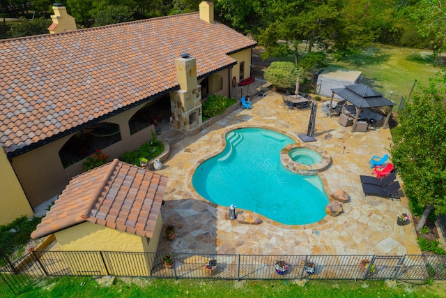 view of pool featuring a patio and an in ground hot tub