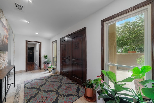 foyer featuring light wood-type flooring and a healthy amount of sunlight