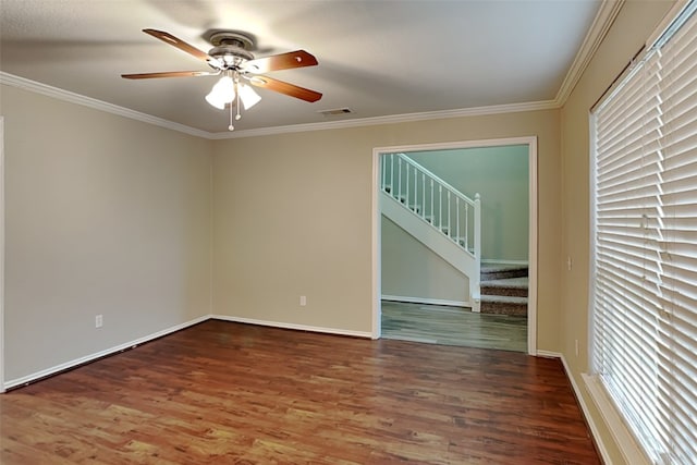 empty room featuring a wealth of natural light, crown molding, hardwood / wood-style floors, and ceiling fan