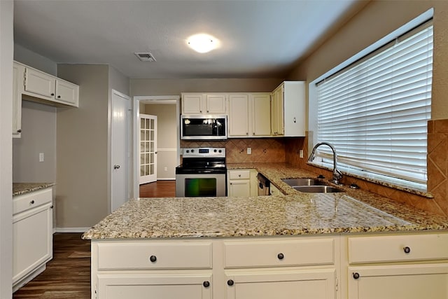 kitchen with backsplash, dark wood-type flooring, sink, appliances with stainless steel finishes, and light stone counters