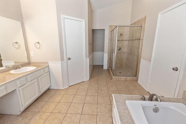 bathroom with vanity, tile patterned flooring, a wainscoted wall, and a stall shower