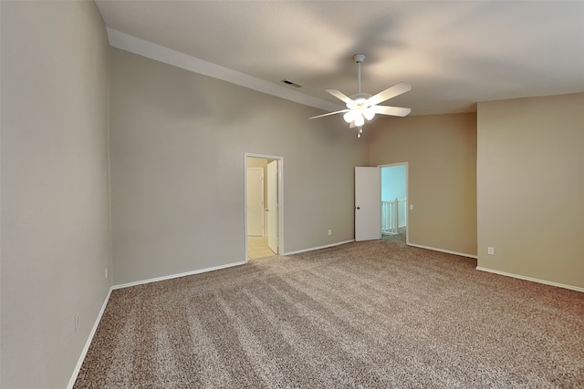 carpeted spare room with ceiling fan