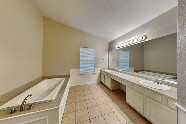 bathroom featuring tile patterned floors, vanity, a textured ceiling, and vaulted ceiling