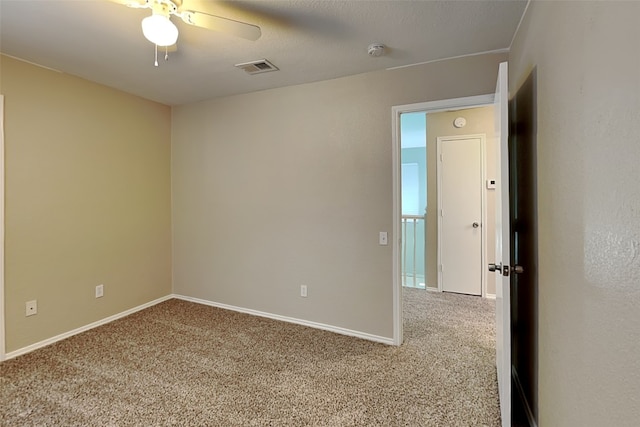 spare room with carpet floors and ceiling fan