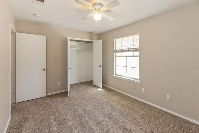 unfurnished bedroom featuring a ceiling fan, baseboards, carpet floors, and a closet