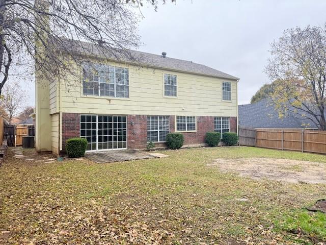 rear view of house with a yard and a patio