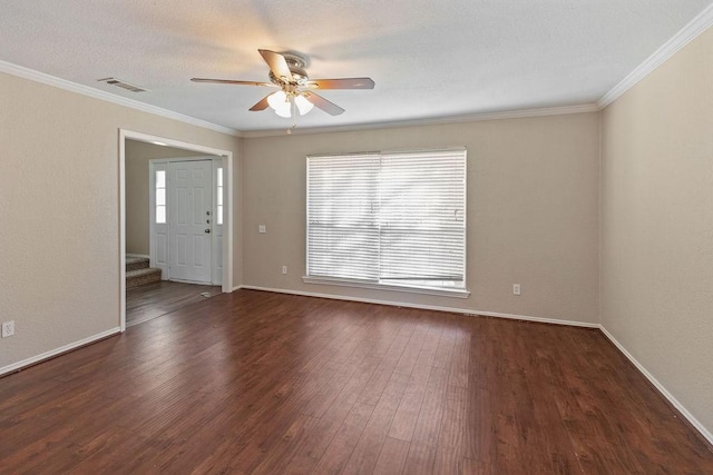 unfurnished room featuring wood finished floors, a ceiling fan, visible vents, and a wealth of natural light