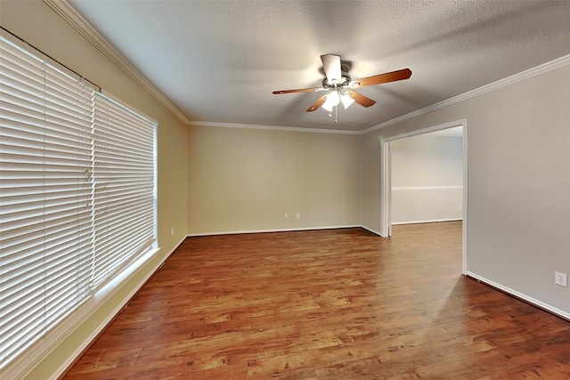 empty room featuring crown molding, hardwood / wood-style floors, ceiling fan, and a textured ceiling