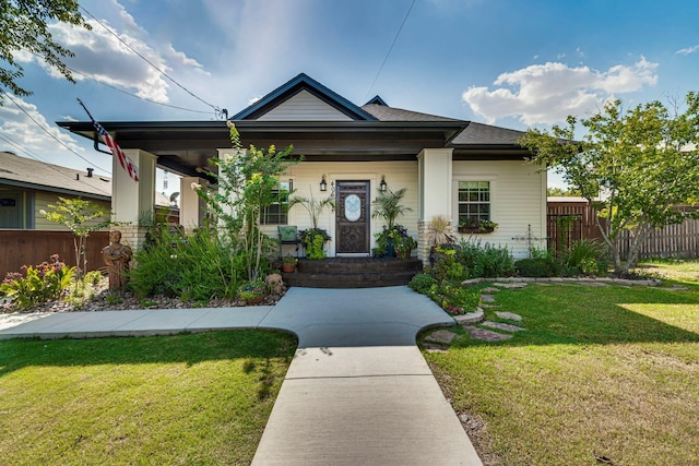 view of front of property with covered porch and a front yard