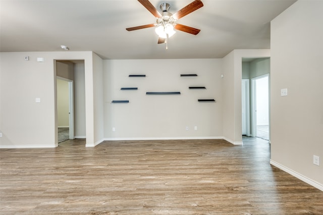 unfurnished room with light hardwood / wood-style flooring and ceiling fan