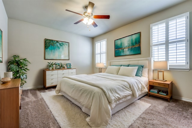 carpeted bedroom with multiple windows and ceiling fan