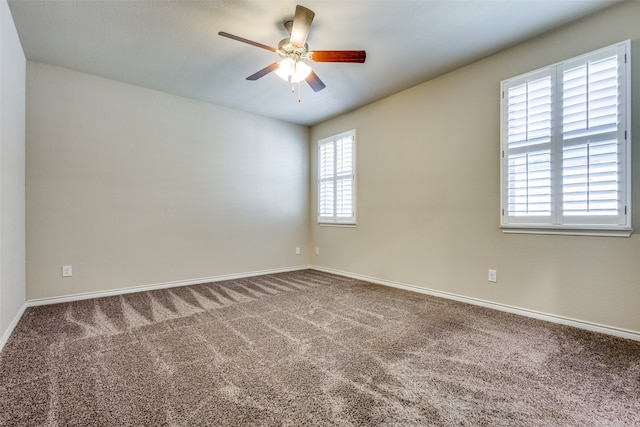 spare room with ceiling fan, carpet flooring, and a healthy amount of sunlight