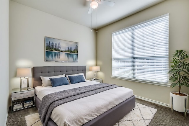 carpeted bedroom with ceiling fan and multiple windows