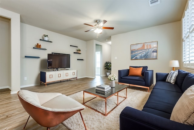 living room featuring light hardwood / wood-style floors and ceiling fan