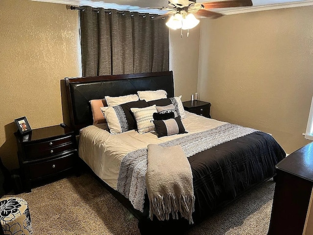 carpeted bedroom featuring ceiling fan and ornamental molding